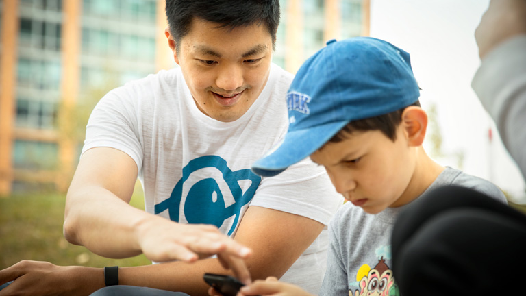 David Cheng demos the Speech Up app to a child